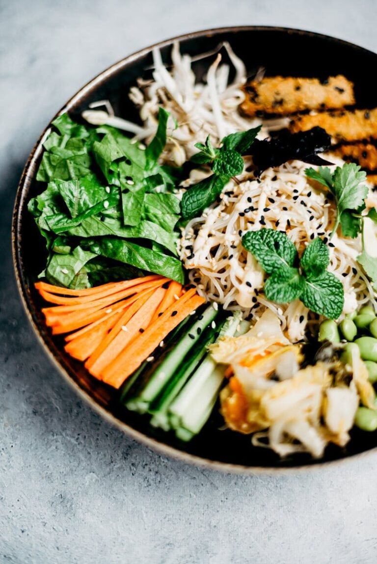 Delicious Asian noodle bowl with fresh vegetables and sesame seeds, perfect for a healthy meal.