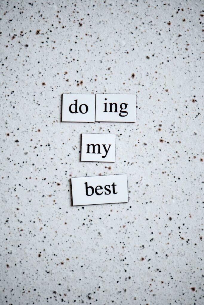 Black and white inspirational quote 'doing my best' on a speckled surface.